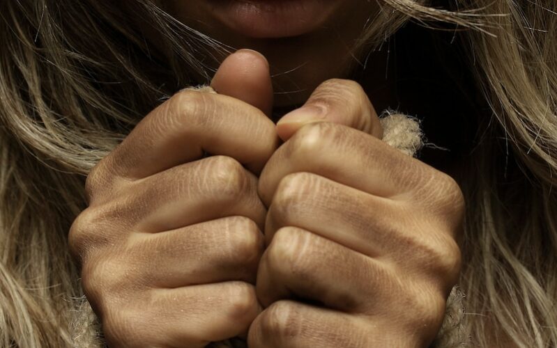woman with hands tied