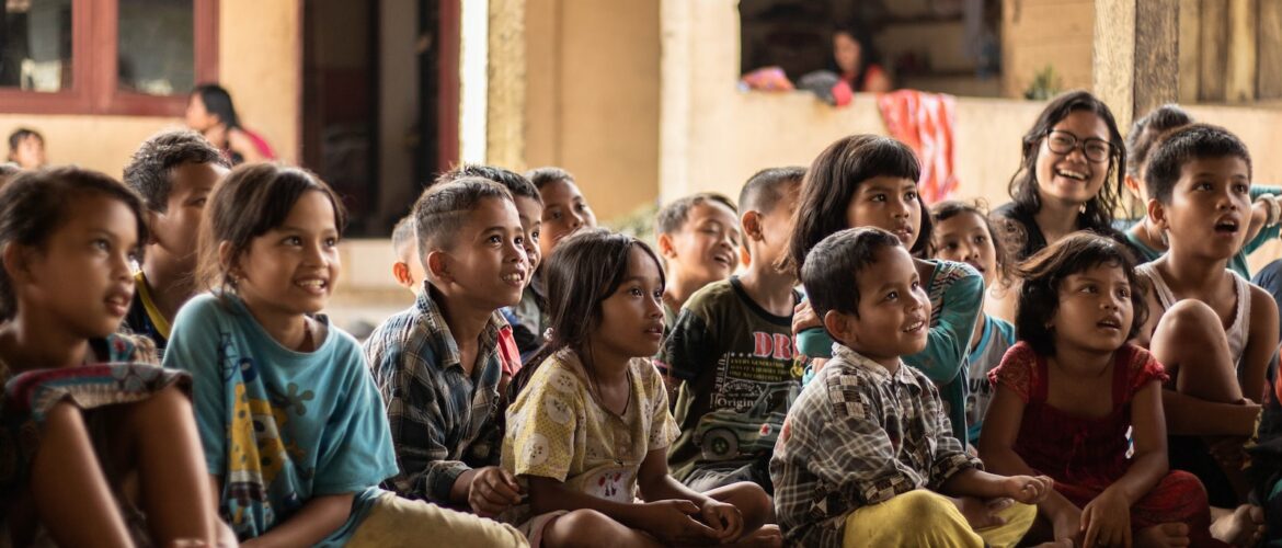 group of childrens sitting on ground